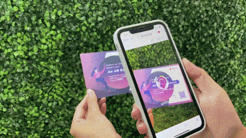 gif demonstrating an AR tour. A young woman stands in front of a large library building, holding up her phone. The image then changes to show her phone, where an AR tour featuring a story and an AR portal are enabled